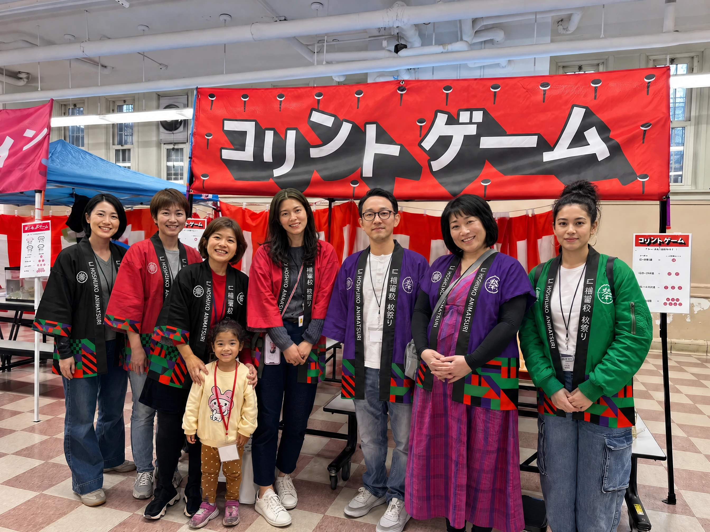 The Korinto Game volunteers in festival happi, lined up under the red noren