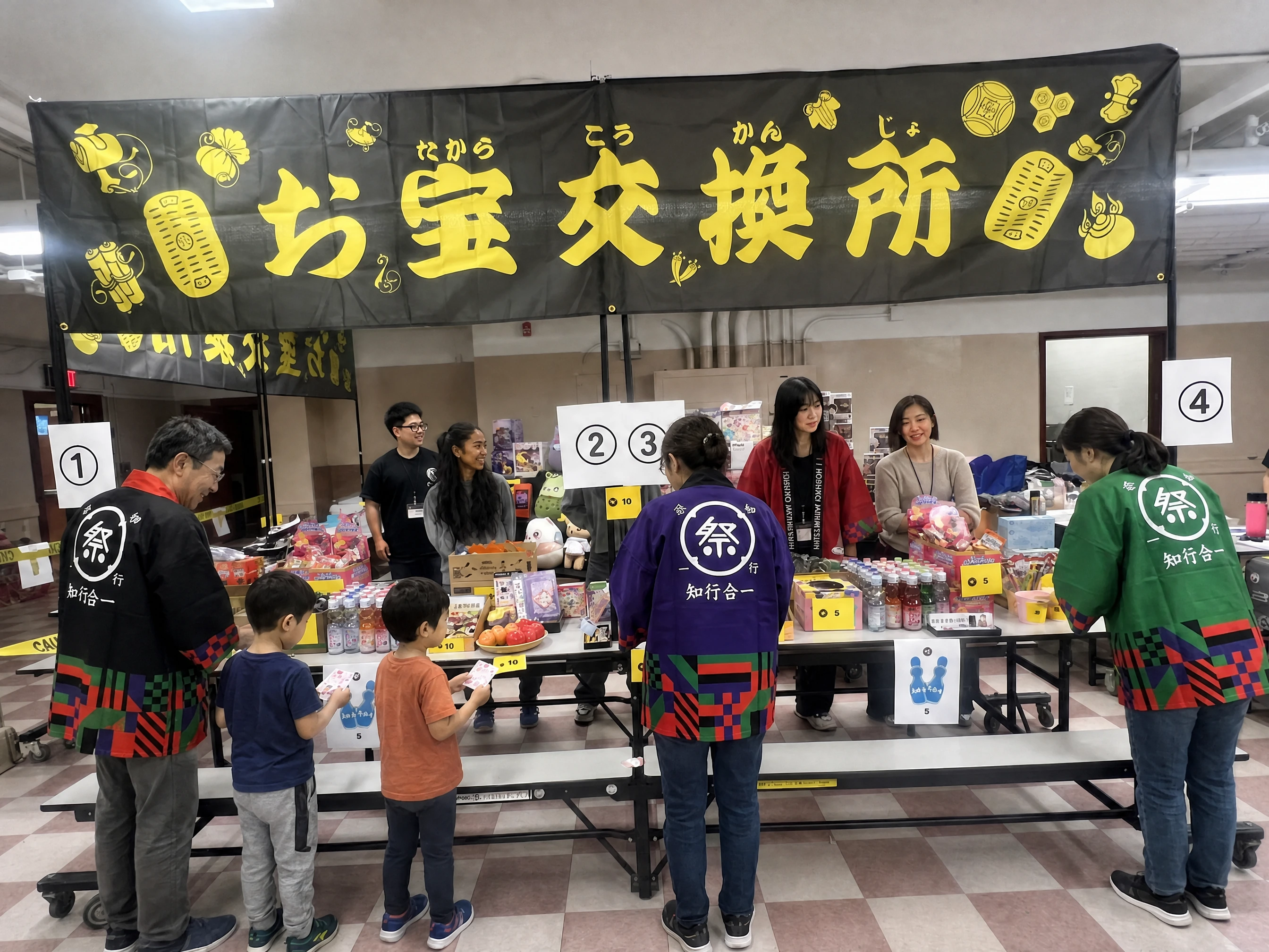 The treasure exchange on the day: prizes laid out on numbered tables under the black-and-yellow noren