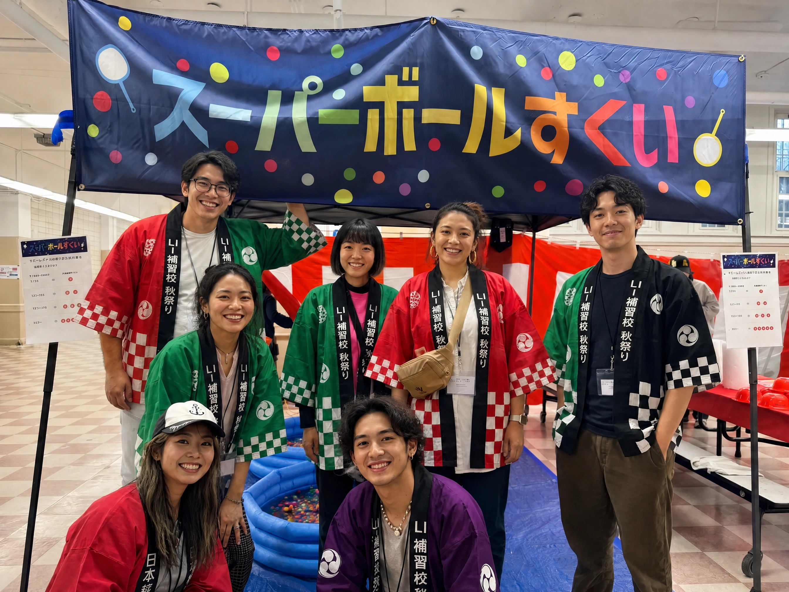 The Superball Sukui volunteers posing under the navy noren beside the paddling pool